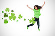 Girl wearing patricks day t-shirt jumping for joy