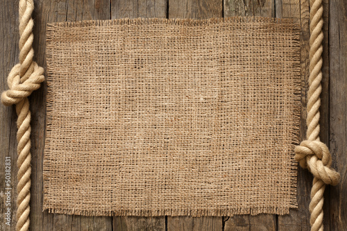 Photo: Old vinatage rope and planks background abstract concept Old vinatage rope and planks background abstract concept