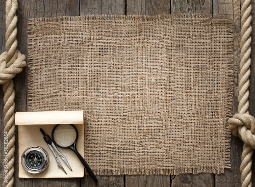Photo: Old wooden planks and rope with compass vintage background Old wooden planks and rope with compass vintage background