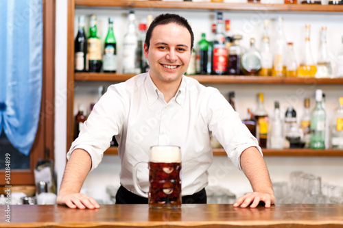 Photo: Bartender offering you a beer Bartender offering you a beer