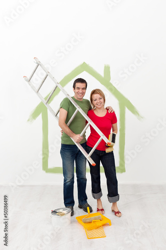 Photo: Happy couple painting their home Happy couple painting their home