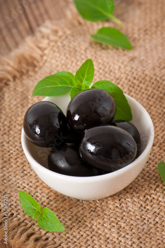 Photo: Black olives on a wooden table Black olives on a wooden table