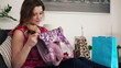 Happy woman checking her shopping bags in home, steadicam shot