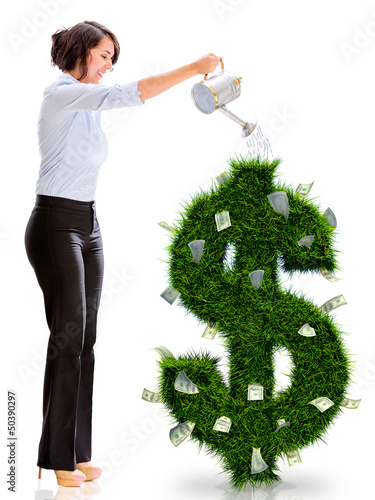 Photo: Business woman watering money plant Business woman watering money plant