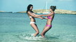 Female friends swirling on the beach, slow motion shot at 240fps