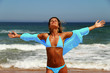 beautiful tanned woman enjoying the sun on the beach.