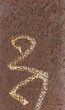 Oxidized metal pillar with white writing