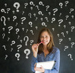 Thinking business woman with chalk question marks