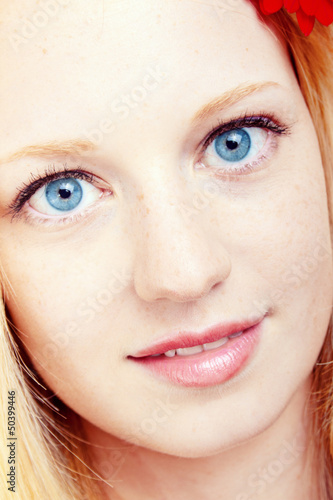 Photo: portrait of a young beautiful blonde girl with flower portrait of a young beautiful blonde girl with flower