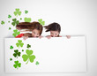 Girls looking down at blank placard with shamrocks
