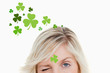 Blonde woman winking on shamrock background