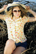 beautiful girl in shorts and hat on grapevine