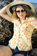 beautiful girl in shorts and hat on grapevine