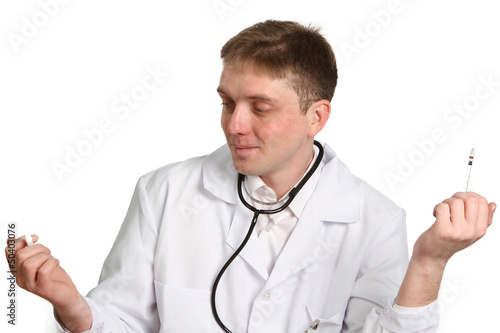 Photo: doctor holding and looking at a syringe isolated on white backg doctor holding and looking at a syringe isolated on white backg