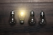 glowing bulb uniqueness concept on wooden background