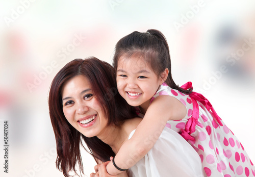 Photo: Asian family piggyback ride at home. Asian family piggyback ride at home.