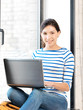 happy teenage girl with laptop computer
