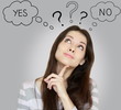Thinking young woman with yes or no choice looking up