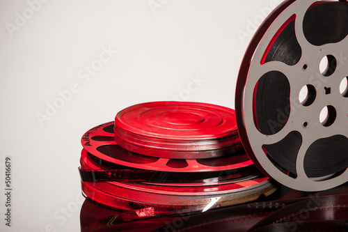 Photo: Film reel with movie film - space for text Film reel with movie film - space for text