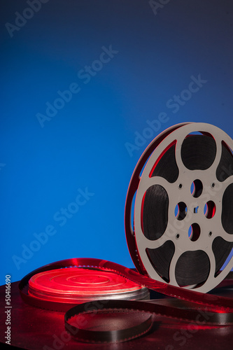 Photo: Film reel with movie film - space for text Film reel with movie film - space for text
