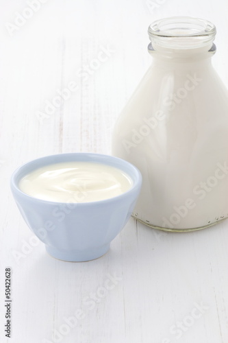 Photo: milk bottle and plain yogurt milk bottle and plain yogurt