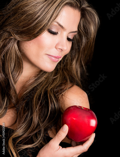 Photo: Beautiful woman holding an apple Beautiful woman holding an apple