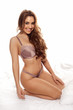 Smiling young curvy woman in lingerie