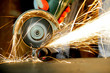 Worker cutting metal with grinder