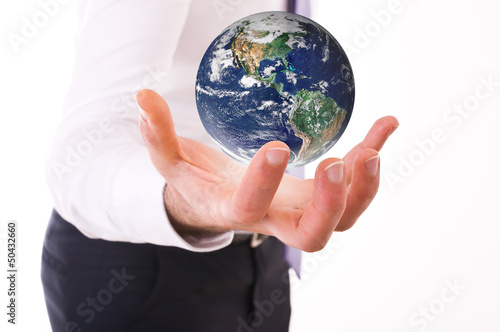 Photo: Business man carrying earth. Business man carrying earth.