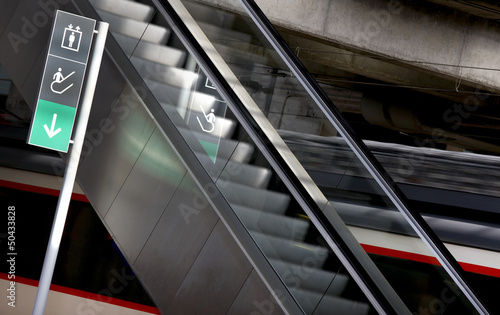 Photo: Signpost and escalators in a railway station Signpost and escalators in a railway station
