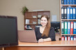 Photo: Beauty woman in office interior with laptop at the desk Beauty woman in office interior with laptop at the desk