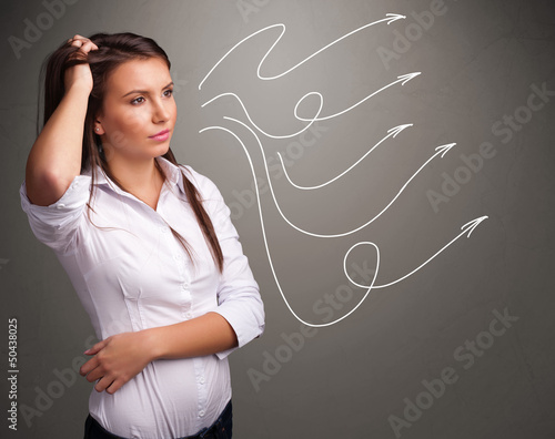 Photo: Attractive teenager looking at multiple curly arrows Attractive teenager looking at multiple curly arrows