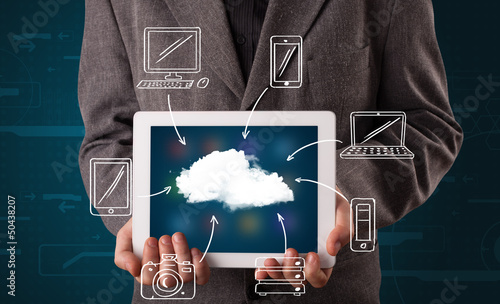 Photo: Businessman showing hand drawn cloud computing Businessman showing hand drawn cloud computing