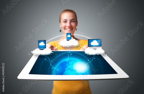 Photo: Young woman holding tablet with modern devices Young woman holding tablet with modern devices