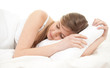 teenage girl sleeping in white bedding