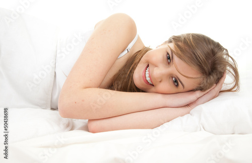 Photo: beautiful girl in white bedding, relaxing beautiful girl in white bedding, relaxing