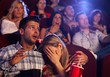 Foto: Young couple watching horror in movie theater Young couple watching horror in movie theater