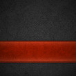 Red leather stripe on black leather background with copyspace -