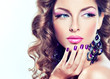 beautiful model with curly hair and purple manicure