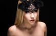 Allure. Woman in Black Carnival Mask with Feathers. View