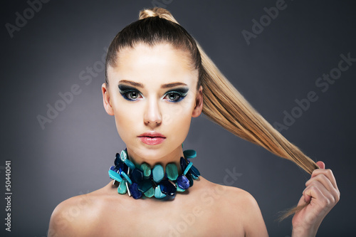 Photo: Treatment. Woman holding Tips of her long faint Hair in hand Treatment. Woman holding Tips of her long faint Hair in hand