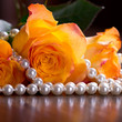 Orange roses in pearls
