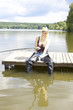 fishing woman sitting on pier