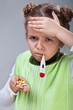 Sick little girl with pills and thermometer