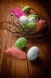Easter eggs in nest on rustic wooden planks