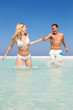 Couple Having Fun In Sea On Beach Holiday