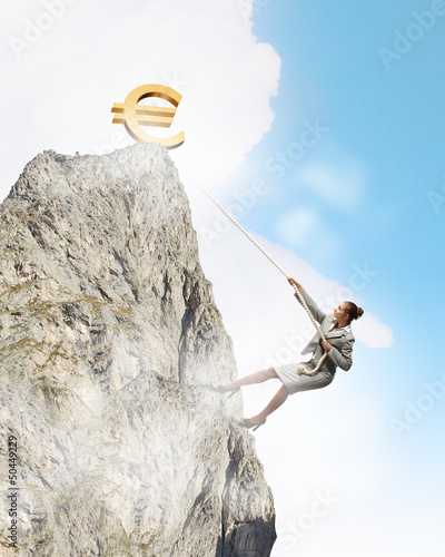 Photo: businesswoman climbing mountain businesswoman climbing mountain