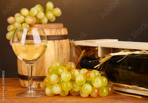 Photo: Wooden case with wine bottle, barrel, wineglass and grape Wooden case with wine bottle, barrel, wineglass and grape
