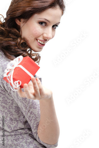 Photo: Pretty woman hands a gift wrapped in red paper Pretty woman hands a gift wrapped in red paper