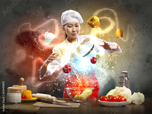 Photo: Asian female cooking with magic Asian female cooking with magic